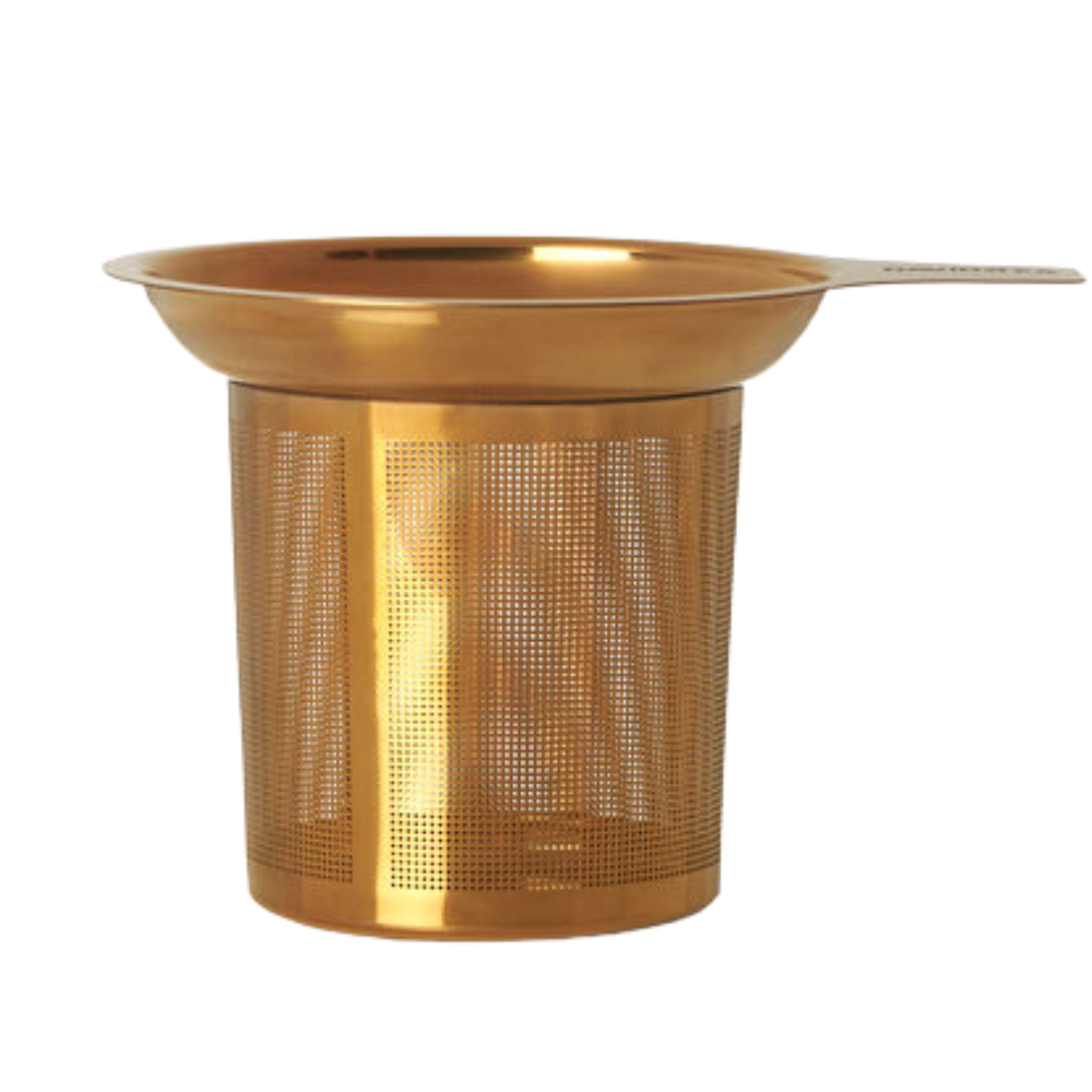 Gold-colored mesh tea infuser on a white background